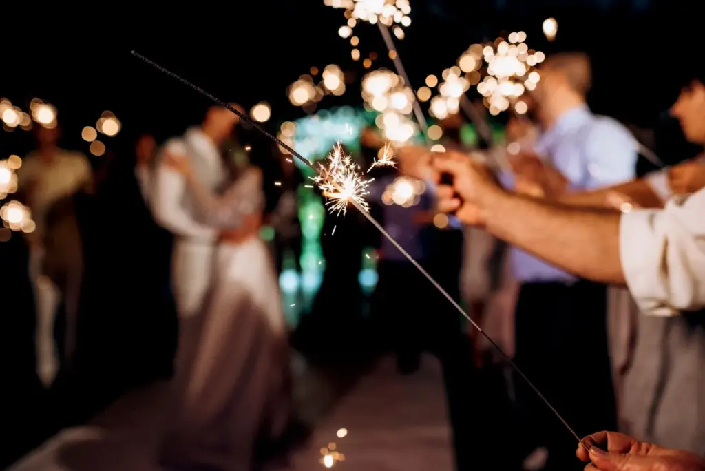 Guests waving sparklers or lanterns