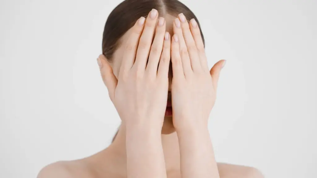 Hands covering part of the face