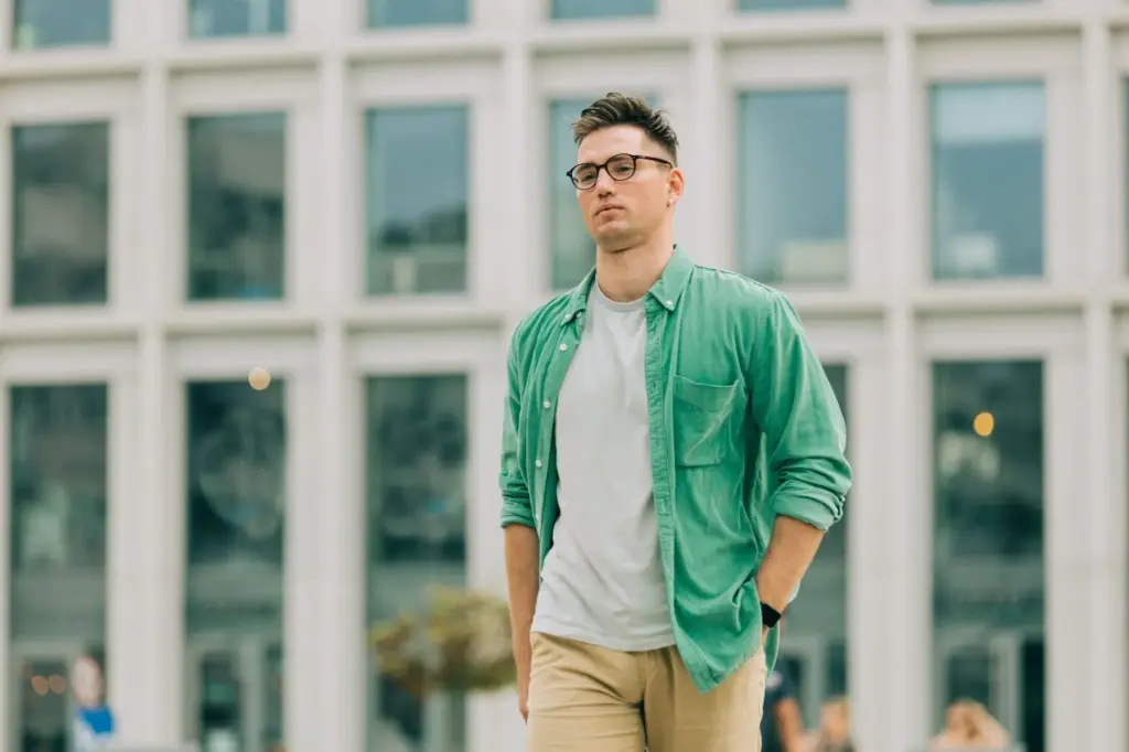 Hands in pockets with a direct gaze