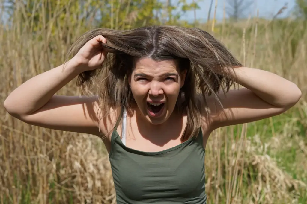 Hands running through hair, a fierce look