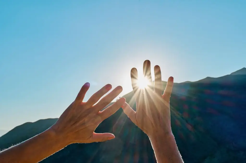 Hands stretched out into the light