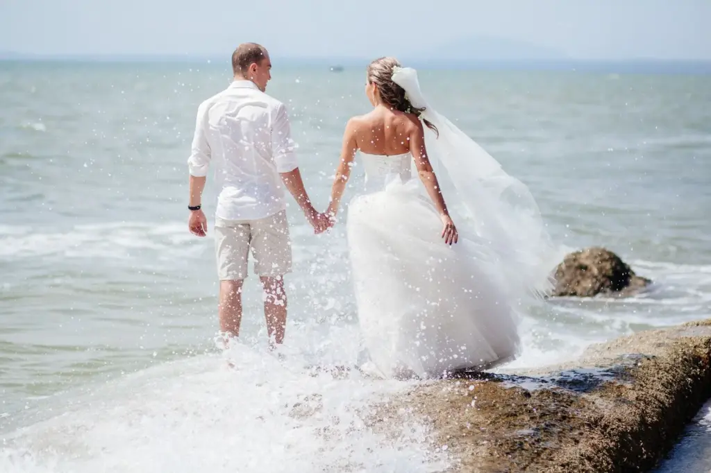 Holding hands with waves crashing nearby