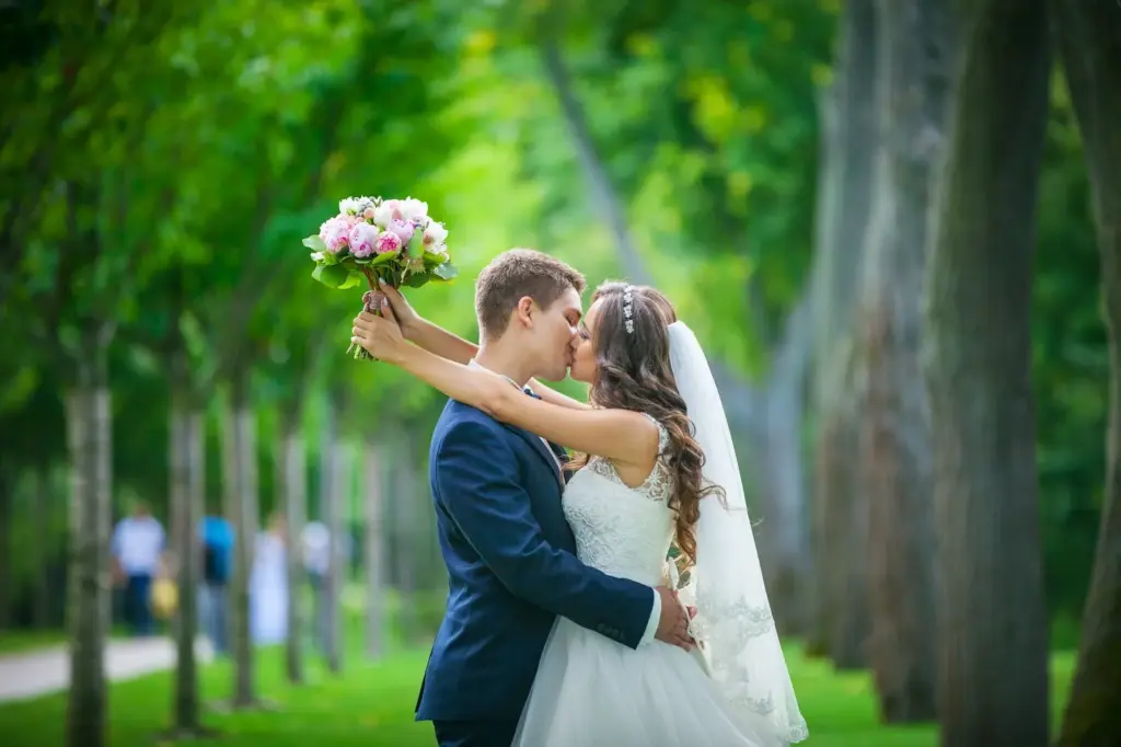 Kiss under a veil with blossoms around