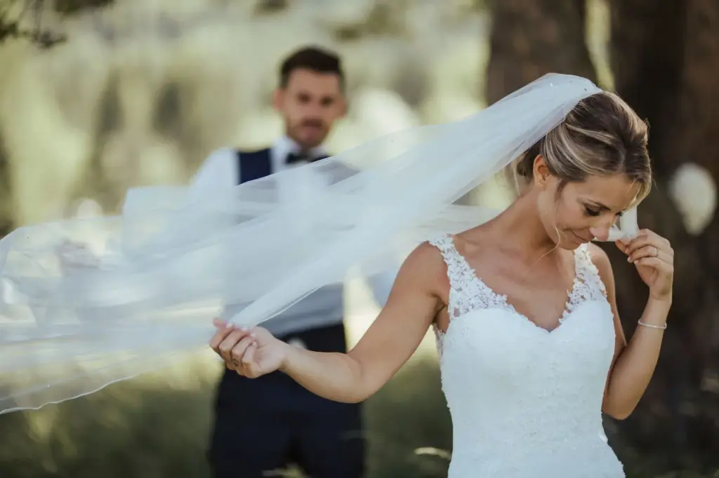 Laughing as the veil catches in the breeze