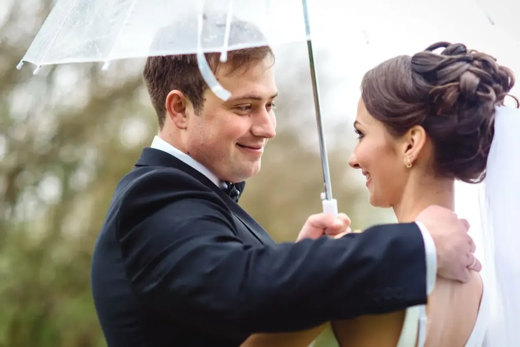 Laughing under a shared umbrella