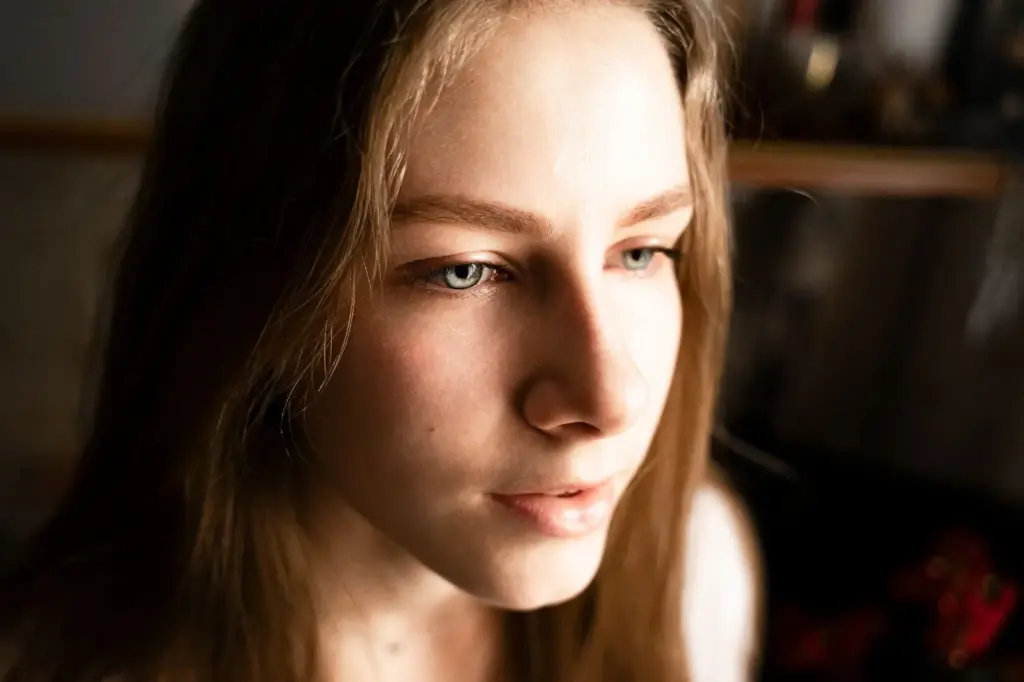 Leaning forward slightly, intense eyes