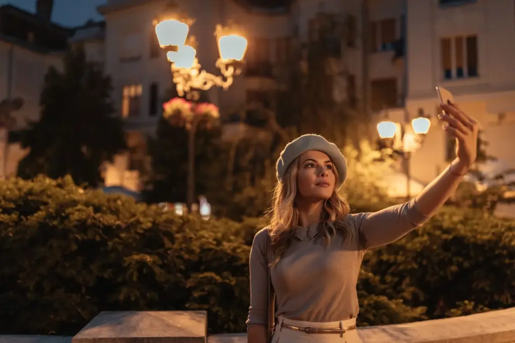 Looking away while standing near a lamp post