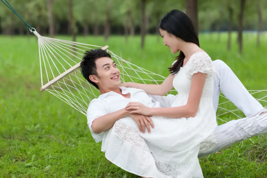 Lying in a hammock under a tree