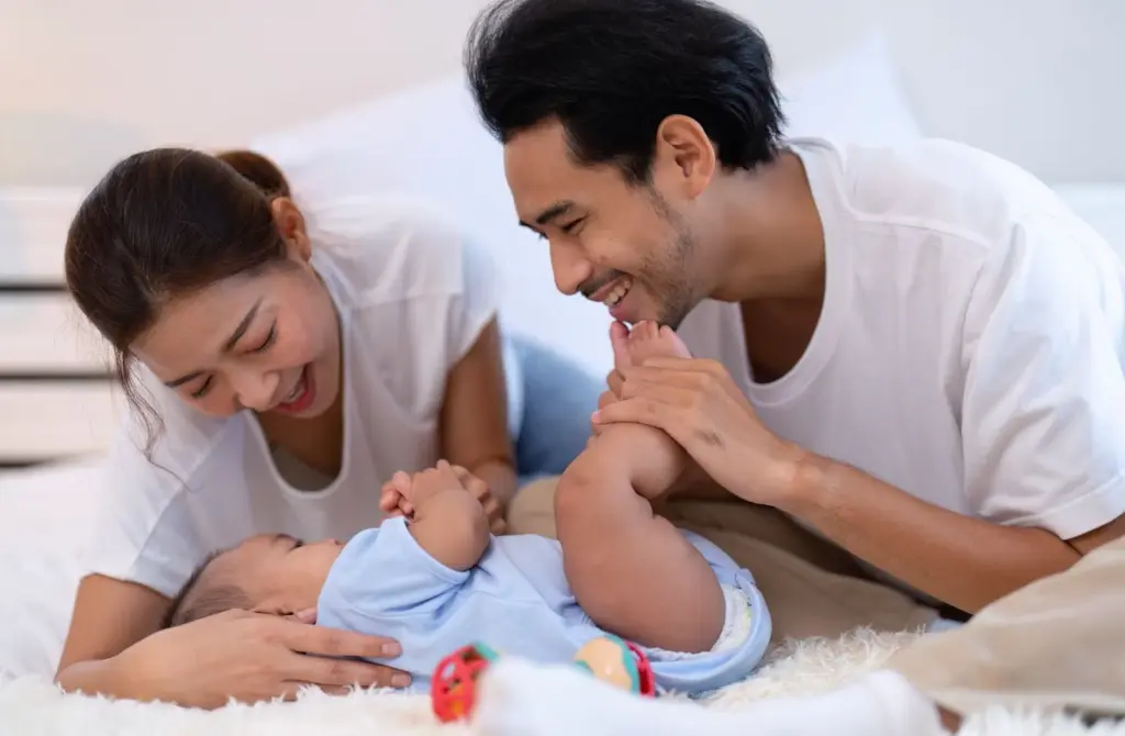 Mother, father, and child are giggling