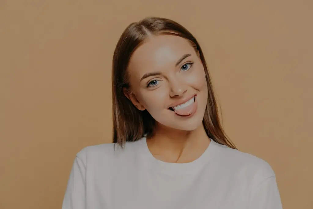 Neutral smile with plain background