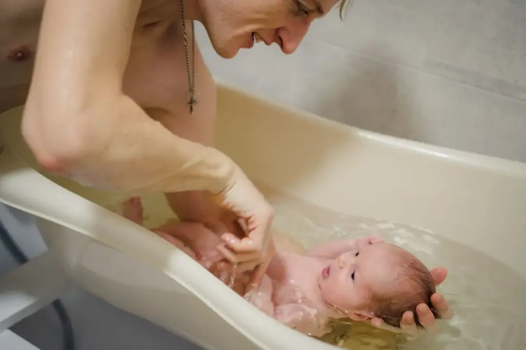 Newborn enjoying his mini tub