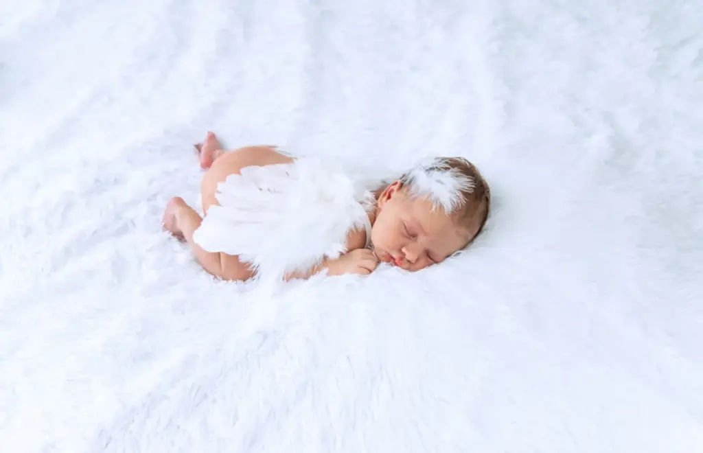 Newborn on a plain white fur rug