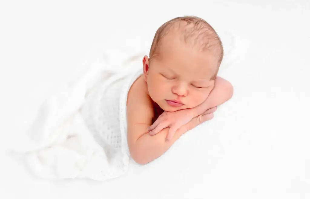 Newborn on white sheets