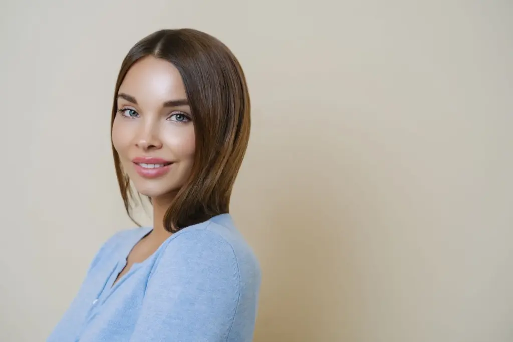 Over-the-shoulder look with a slight smile