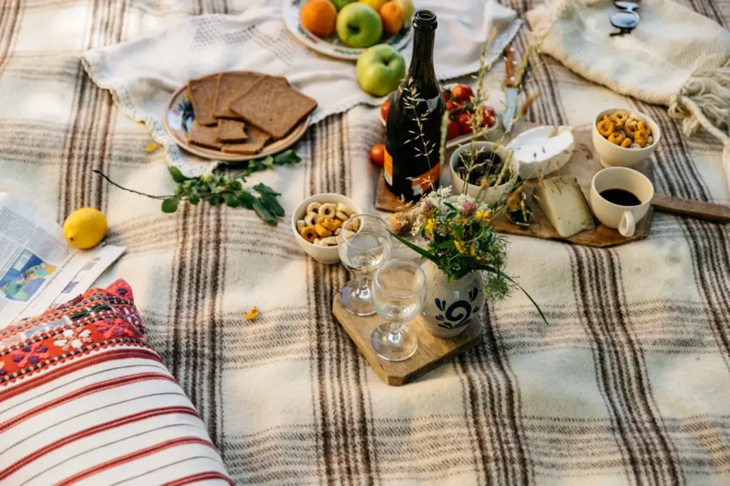 Picnic setup with vintage plates, candles, and lace napkins