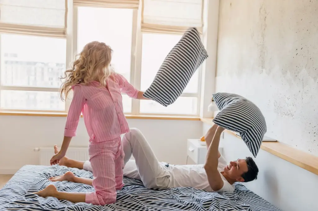 Playful pillow fight moment