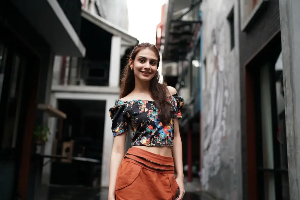 Posing in an alley with arms confidently crossed