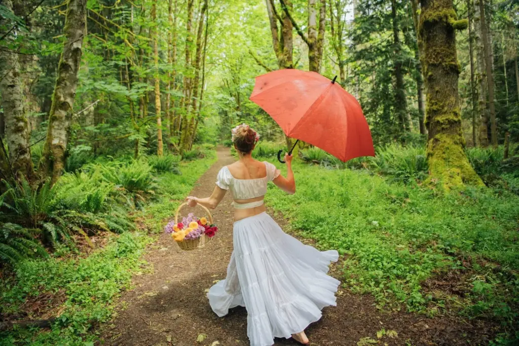 Posing with a vintage umbrella and other props