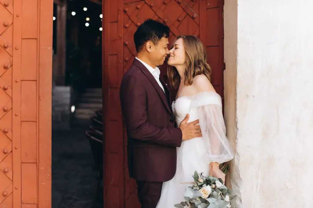 Rustic gate or old wooden door framing a couple