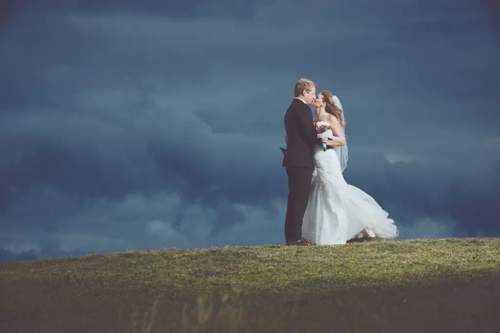 Silhouette kiss against a snowy sky