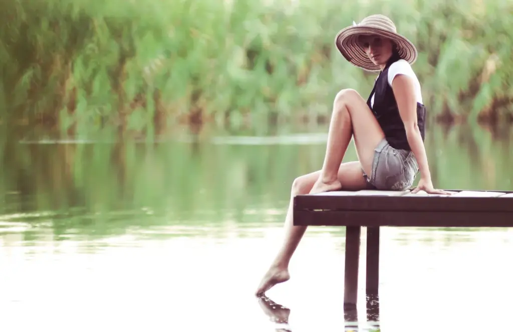 Sitting lakeside with legs in water