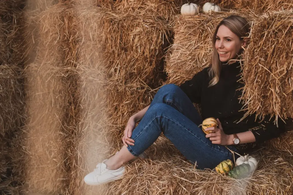 Sitting on a haystack and smiling