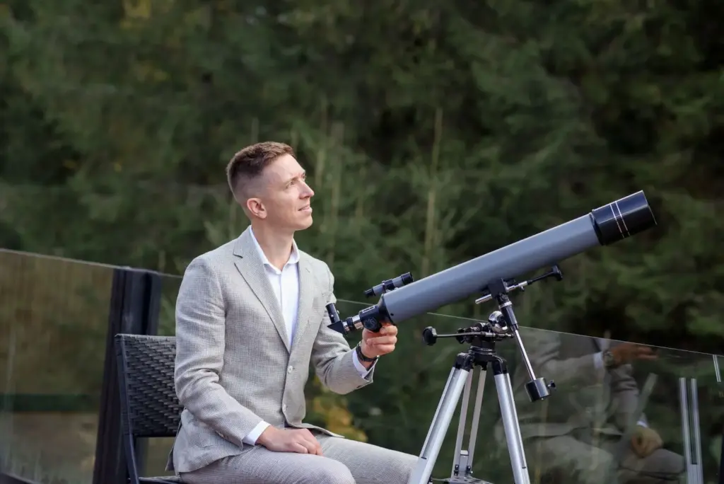 Sitting on a rooftop with a telescope