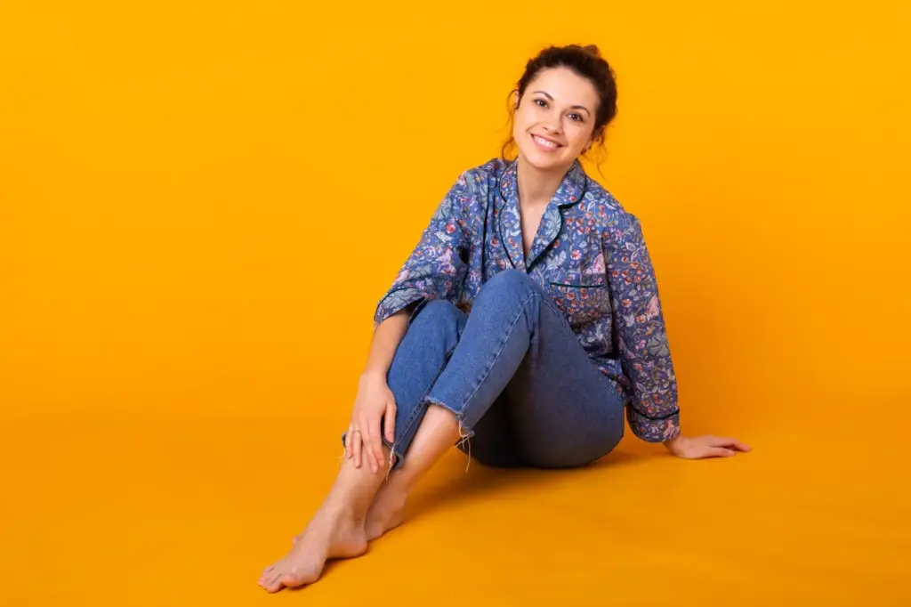 Sitting while facing the camera and legs slightly turned