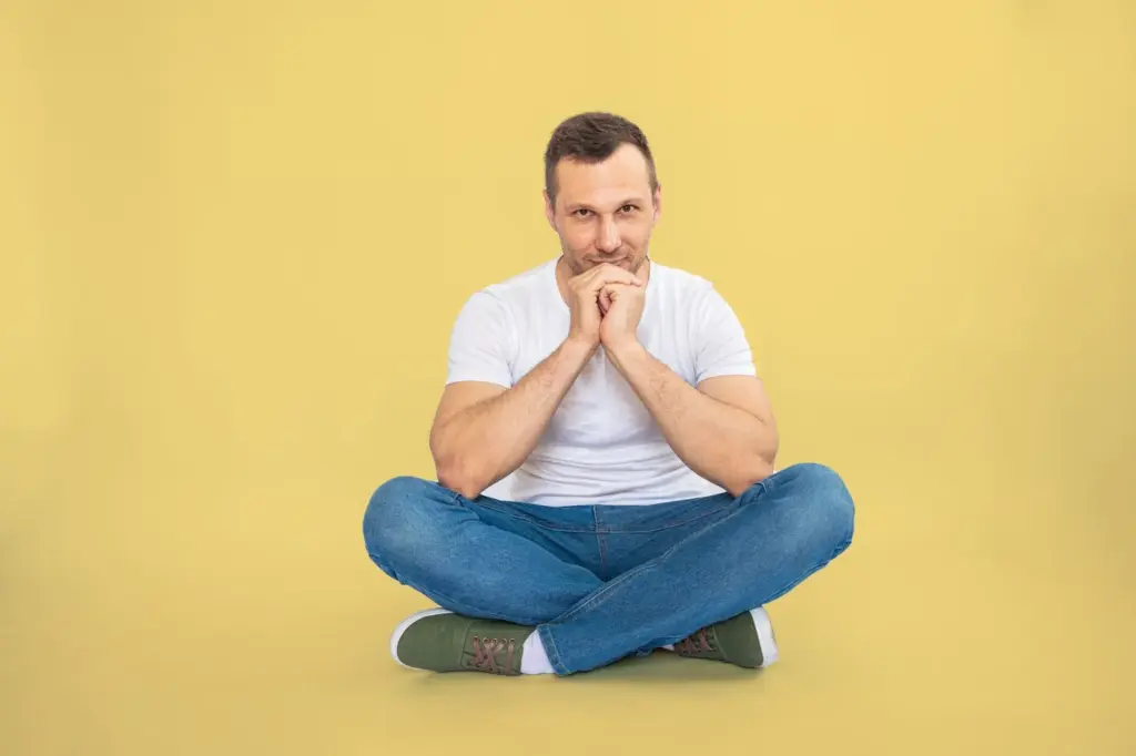 Sitting with crossed legs and a confident gaze