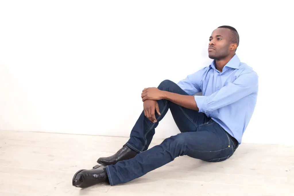 Sitting with legs extended and relaxed