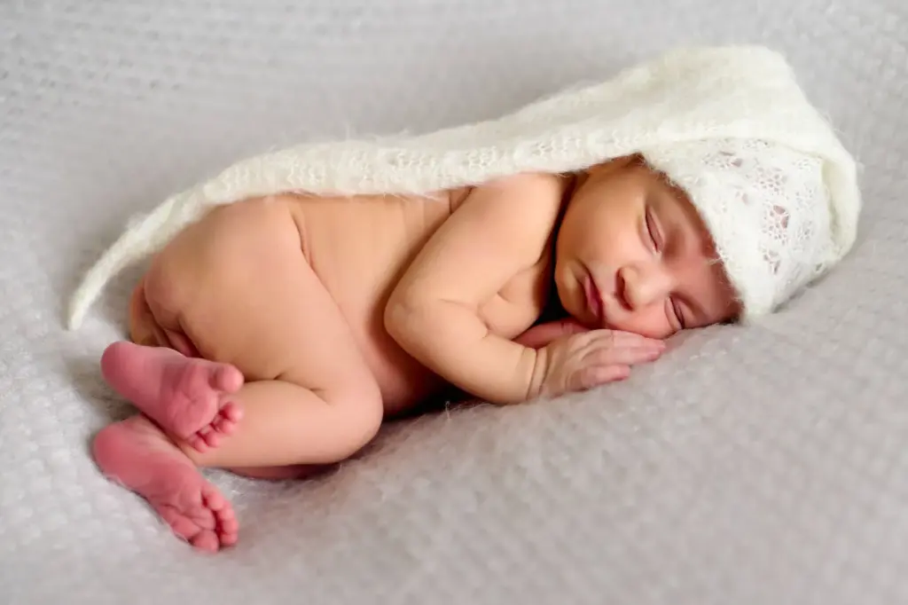 Sleeping with arms and legs slightly curled