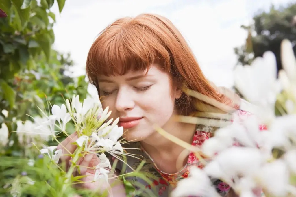 Smelling the garden flowers with closed eyes