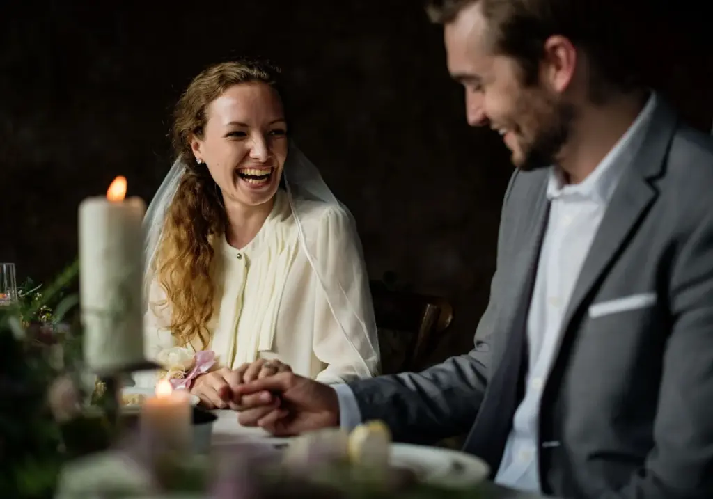 Smiling at each other over a candlelit table