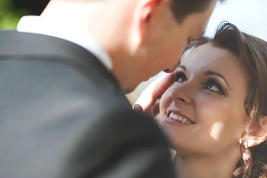 Soft, tender smile as he locks eyes with his bride