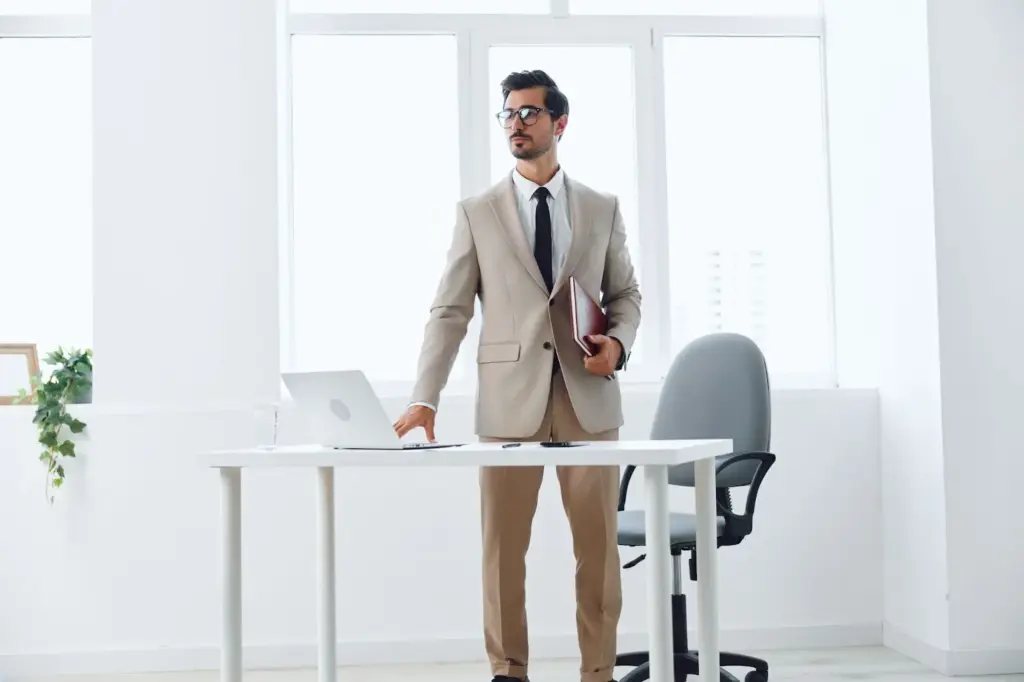 Standing confidently beside a work table