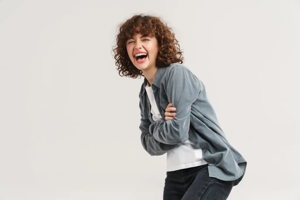 Subtle laugh while looking down