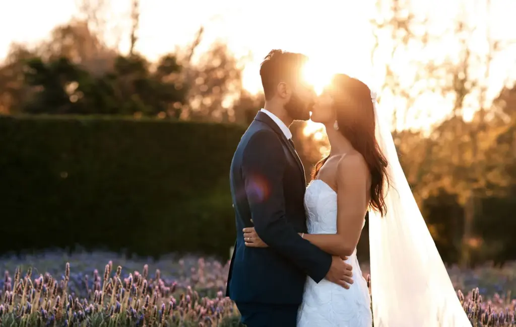 Sunset kiss with lens flare and warm tones