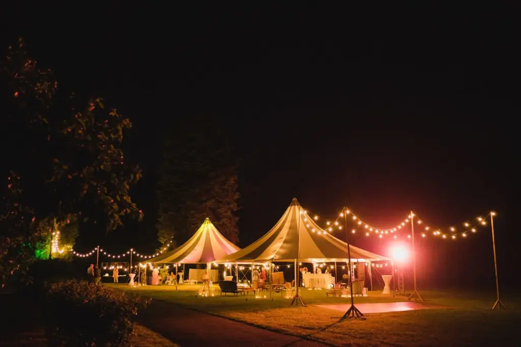 Tent or cabin glowing under a star-filled sky