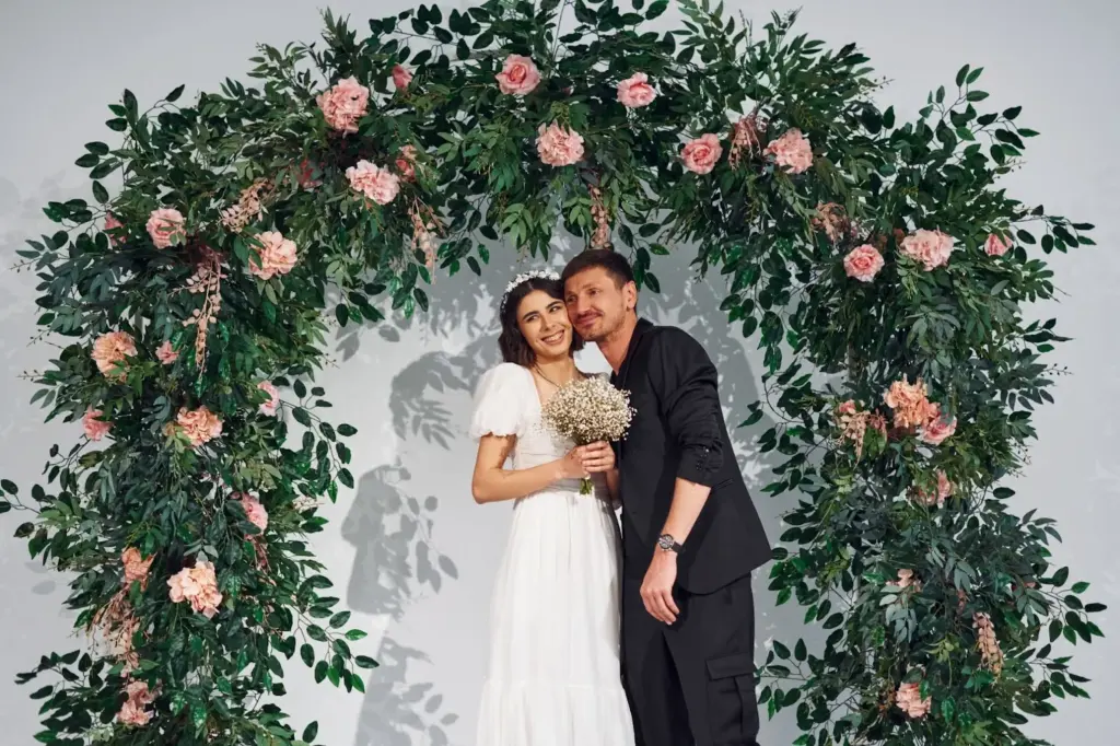 The couple shot under floral arches or natural greenery