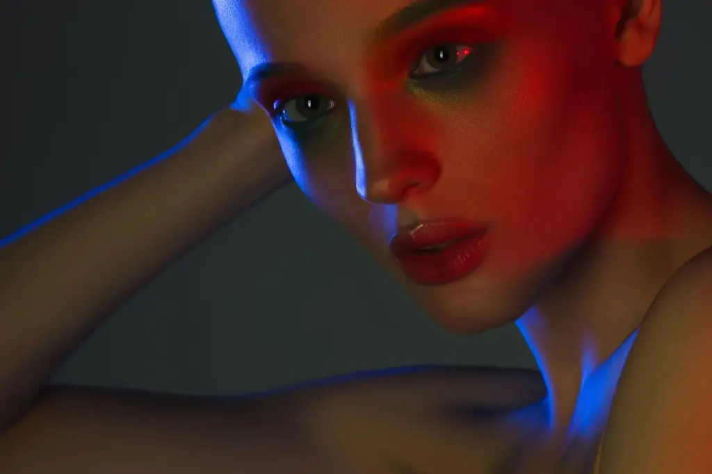 Tilted head under a coloured spotlight