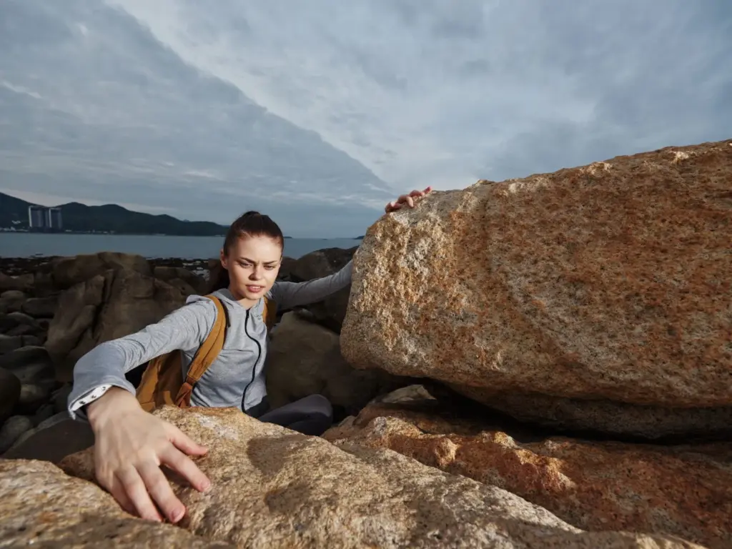 Touching the surface of the rocky cliff