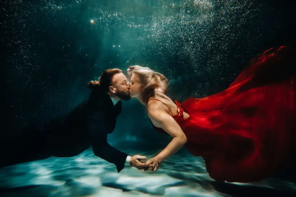 Underwater kiss in a clear blue pool