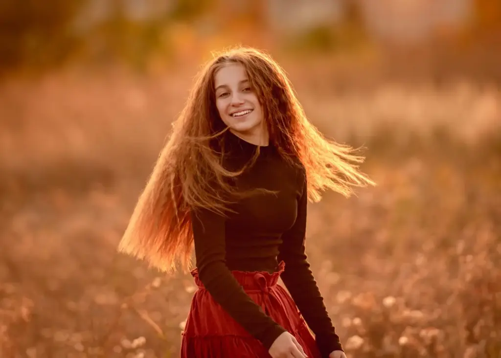 Wind-blown hair glowing in the golden hour light