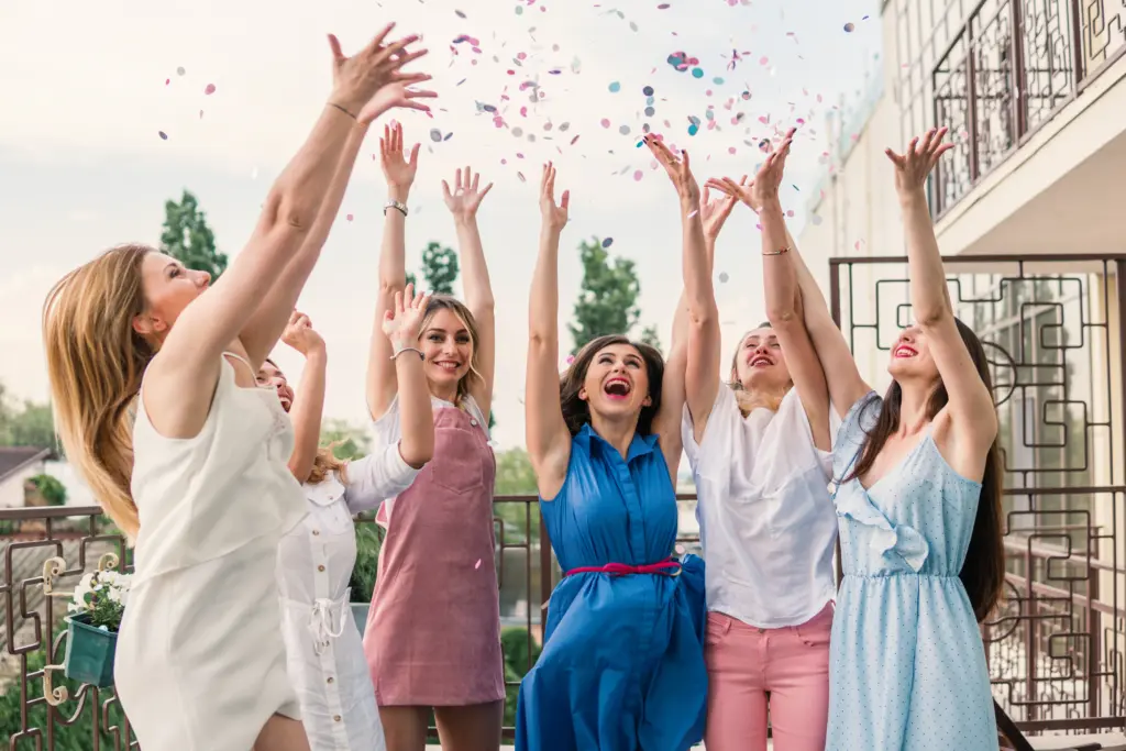 20+ Creative Group Wedding Photo Ideas for Family and Friends 75 A Fun and Festive Confetti Toss with the Bride Tribe