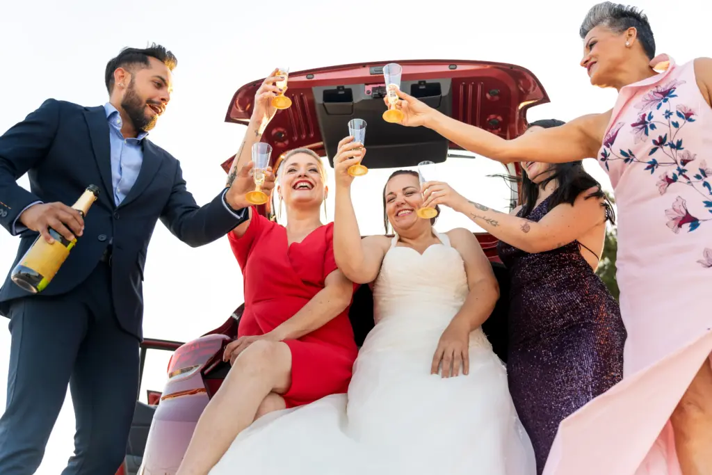 20+ Creative Group Wedding Photo Ideas for Family and Friends 47 Bride and friends toasting with champagne after wedding ceremony