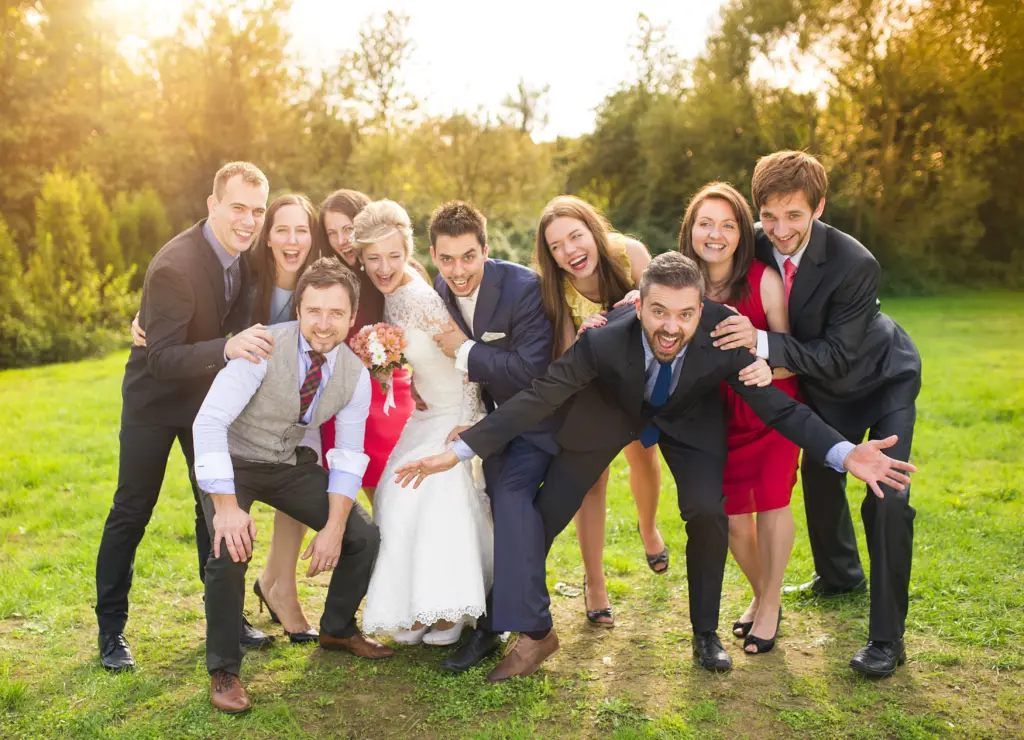 20+ Creative Group Wedding Photo Ideas for Family and Friends 16 Newlywed couple having fun with bridesmaids and groomsmen