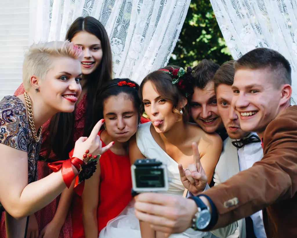 20+ Creative Group Wedding Photo Ideas for Family and Friends 30 Group of millennial friends funny posing in camera go pro at wedding