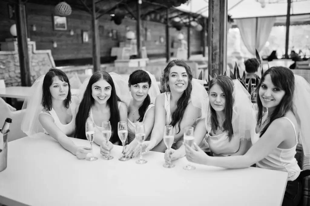 20+ Creative Group Wedding Photo Ideas for Family and Friends 101 Group of cheerful girls at white shirts sitting at table