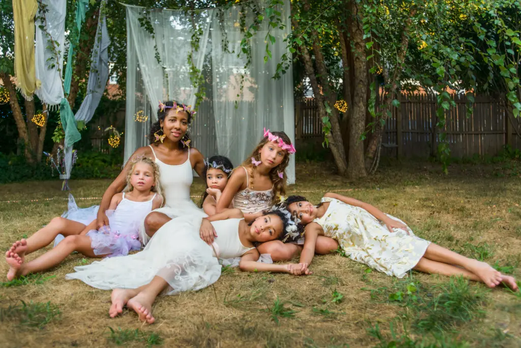 20+ Creative Group Wedding Photo Ideas for Family and Friends 87 Portrait of mature woman with group of young girls, dressed as fairies, outdoors
