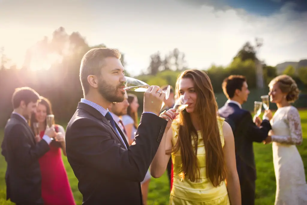 20+ Creative Group Wedding Photo Ideas for Family and Friends 48 Wedding Guests Toasting While Newlyweds Cheers